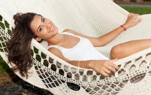 Picture of a happy woman in a hammock.